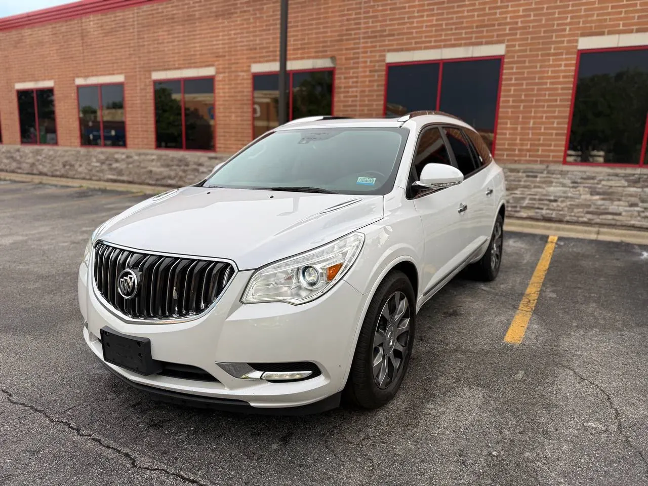 White Buick Enclave parked outside